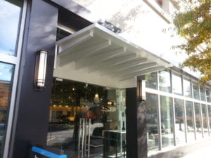 Suspended awnings that rely on hanger rods, support arms, or other overhead support are popular among brick-and-mortar business owners. Our Custom Canvas Works professionals can design custom aluminum suspended canopies that meet your individualized needs.